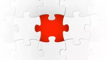 Red puzzle piece in a completed white puzzle.