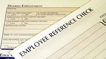 Close-up of employment and reference check forms.